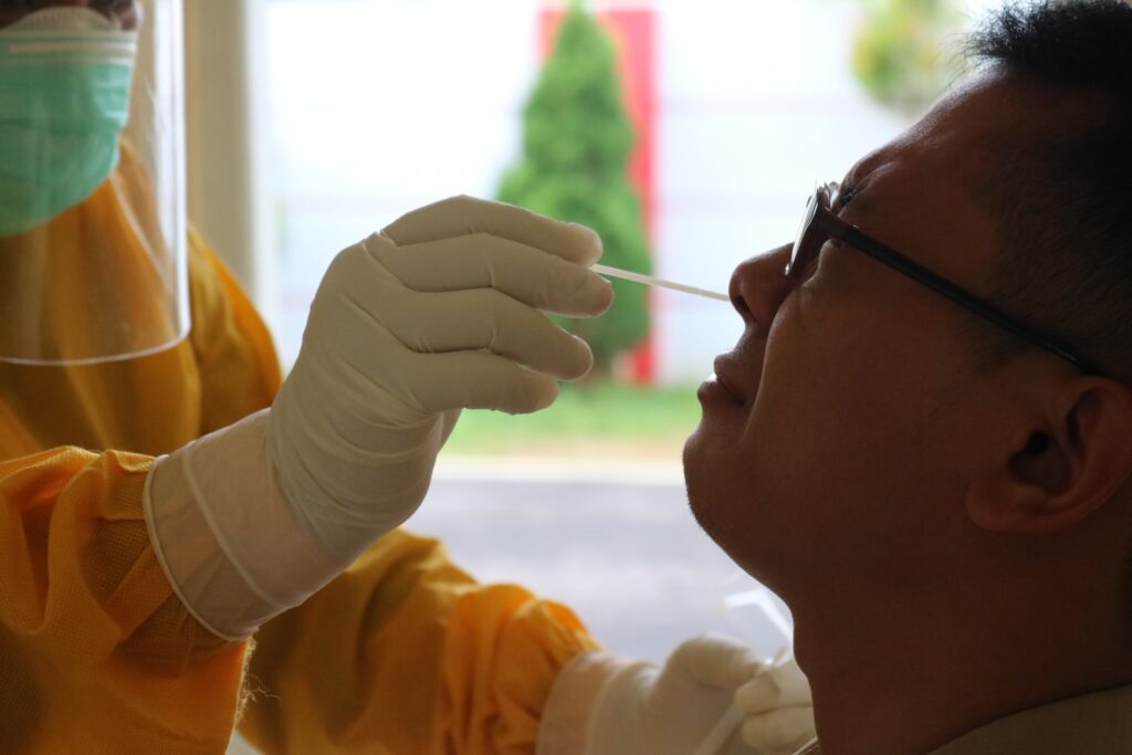 man being swab tested for covid-19